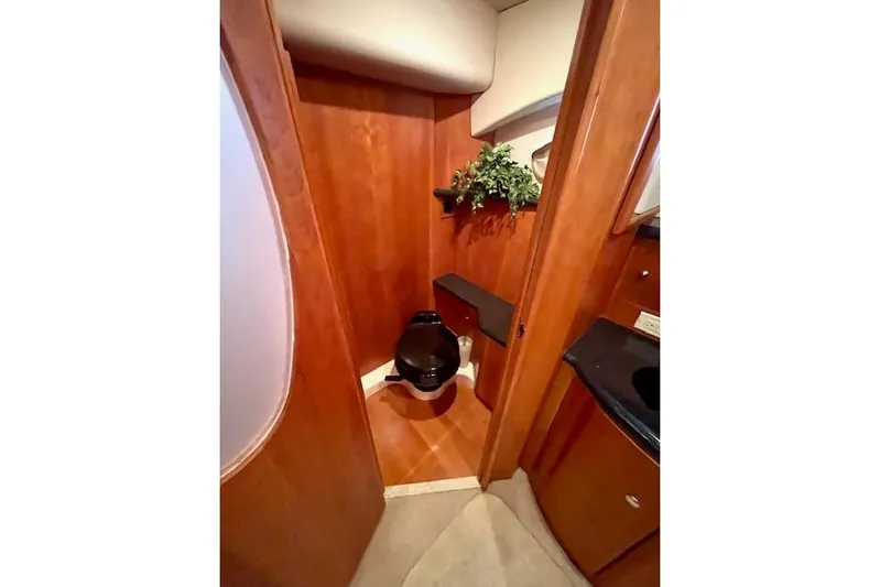 "sunseeker" Yacht Photos Pics Luxurious bathroom in 2002 Silverton 43 Motor Yacht with wood paneling and modern fixtures.