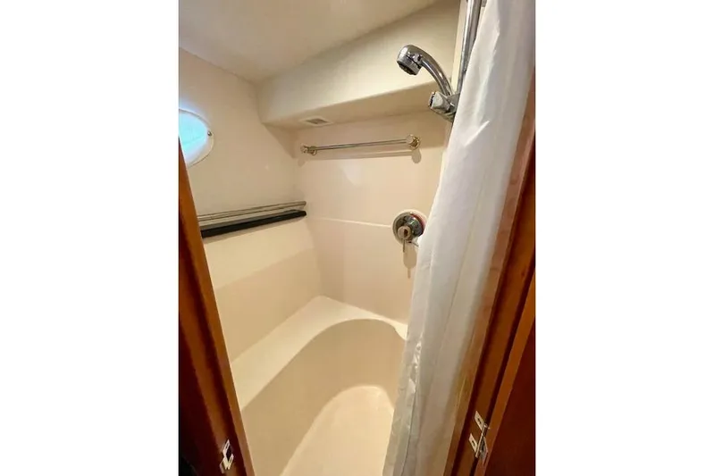 "sunseeker" Yacht Photos Pics Bathroom interior of 2002 Silverton 43 Motor Yacht with shower and porthole.