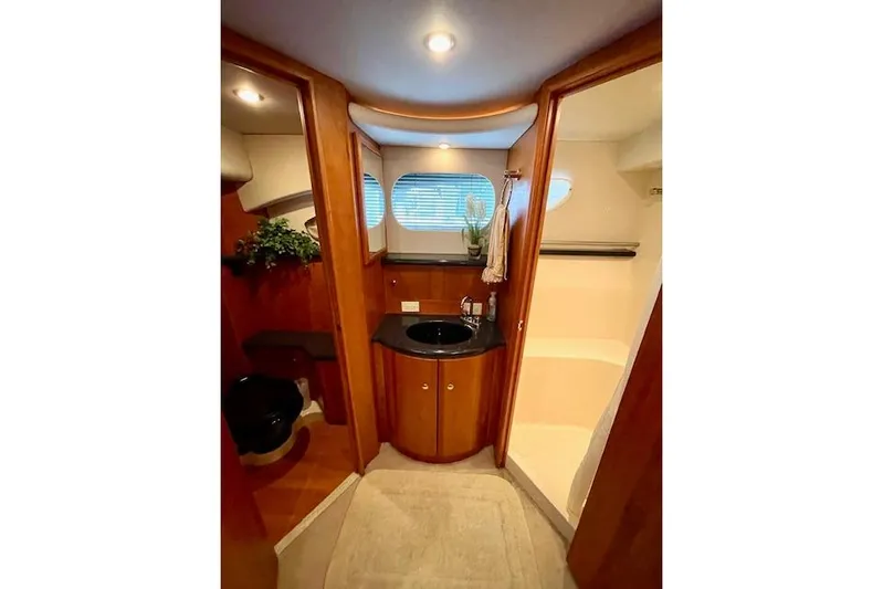 "sunseeker" Yacht Photos Pics Luxurious bathroom interior of 2002 Silverton 43 Motor Yacht with wood accents and modern fixtures.