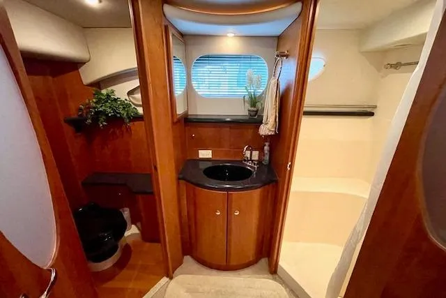 "sunseeker" Yacht Photos Pics Luxurious bathroom interior of 2002 Silverton 43 Motor Yacht with wood accents and modern fixtures.