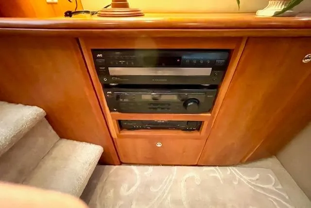 "sunseeker" Yacht Photos Pics 2002 Silverton 43 Motor Yacht interior with built-in audio system and wooden cabinetry.