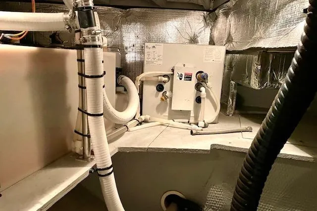 "sunseeker" Yacht Photos Pics Engine room of 2002 Silverton 43 Motor Yacht with visible piping and equipment.