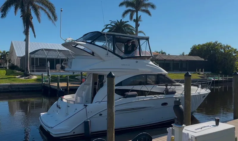Compass Rose Yacht Photos Pics 2006 Meridian 341 Sedan yacht docked by palm trees and waterfront homes.