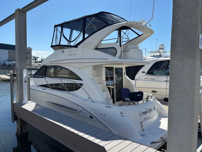 Compass Rose Yacht Photos Pics 2006 Meridian 341 Sedan yacht docked at marina, featuring sleek design and spacious upper deck.