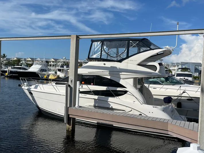 Compass Rose Yacht Photos Pics 2006 Meridian 341 Sedan yacht docked at a marina under a clear blue sky.
