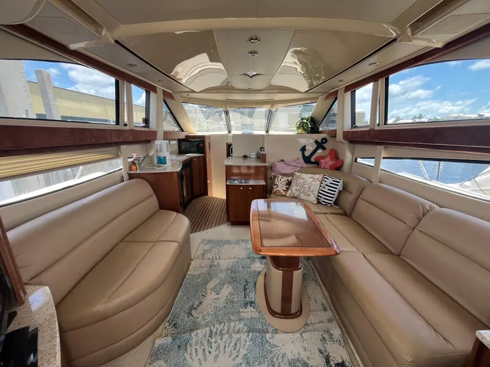 Compass Rose Yacht Photos Pics Luxurious interior of a 2006 Meridian 341 Sedan yacht with plush seating and elegant decor.
