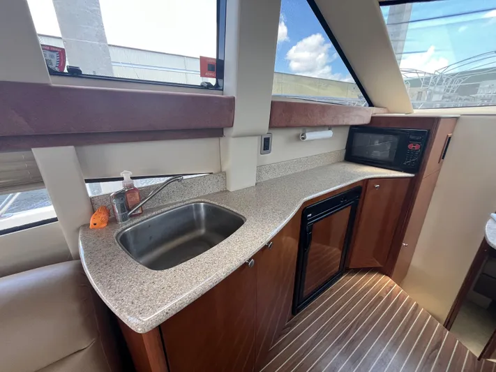 Compass Rose Yacht Photos Pics 2006 Meridian 341 Sedan yacht kitchen with sink, microwave, and countertop.