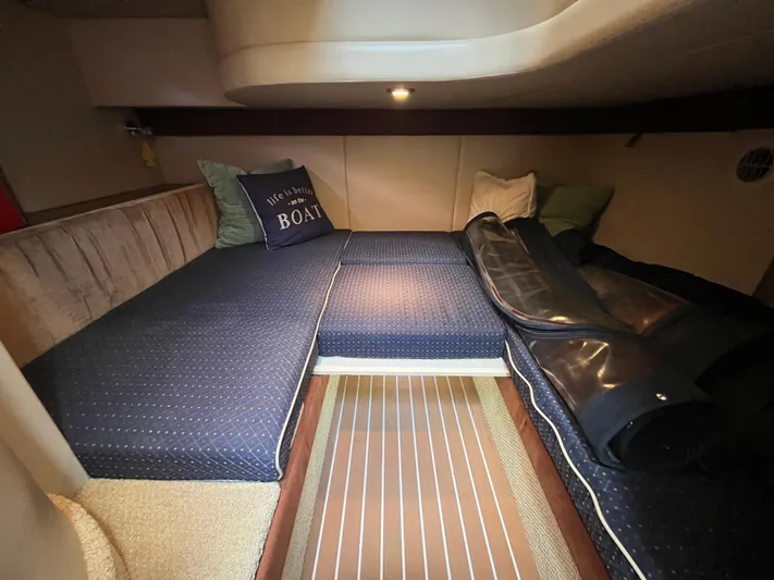 Compass Rose Yacht Photos Pics Cozy cabin interior of 2006 Meridian 341 Sedan with blue bedding and decorative pillows.