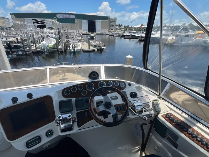 Compass Rose Yacht Photos Pics Cockpit view of 2006 Meridian 341 Sedan at marina, showcasing controls and waterfront.