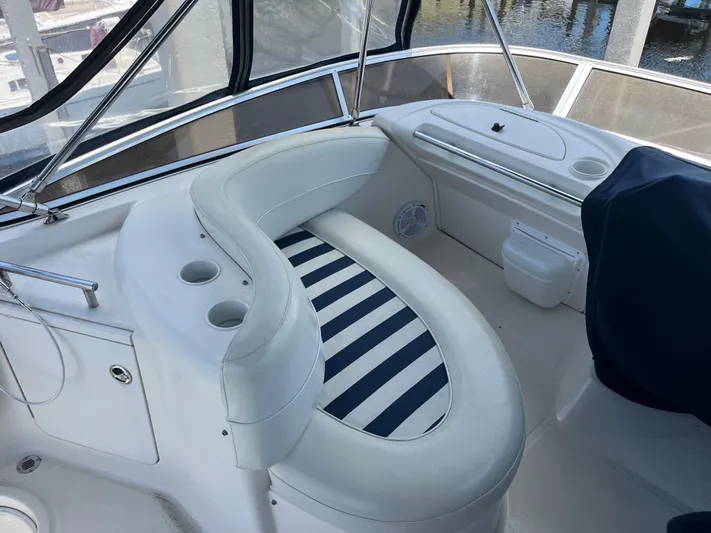 Compass Rose Yacht Photos Pics 2006 Meridian 341 Sedan boat interior with striped seating and cup holders.