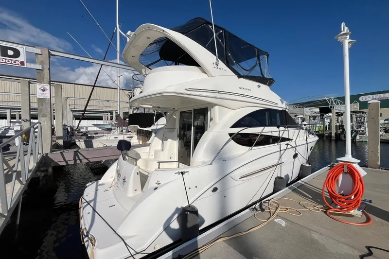 Compass Rose Yacht Photos Pics 2006 Meridian 341 Sedan yacht docked at marina under clear blue sky.