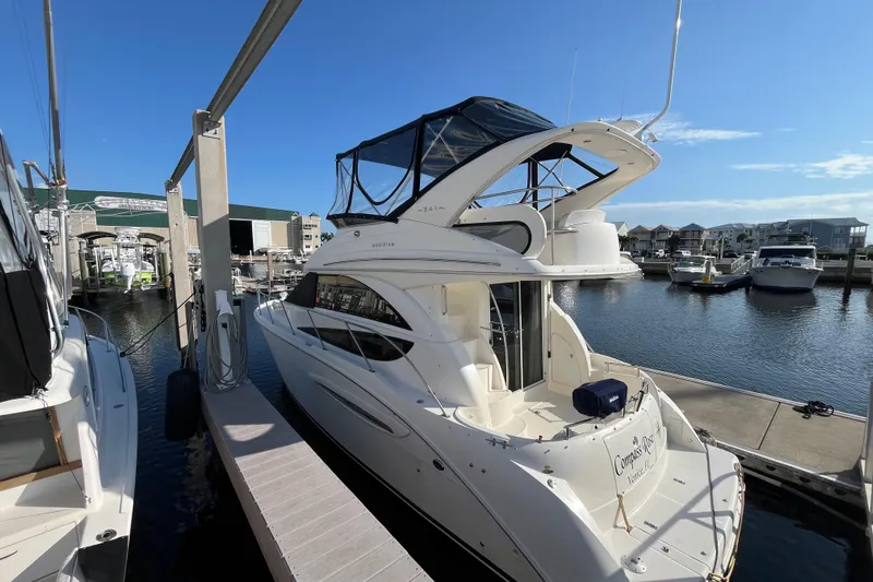Compass Rose Yacht Photos Pics 2006 Meridian 341 Sedan yacht docked at marina under clear blue sky.