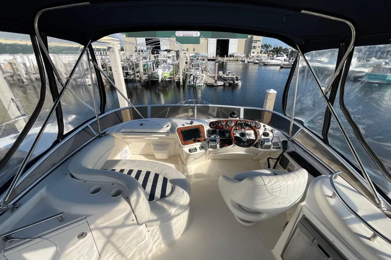 Compass Rose Yacht Photos Pics 2006 Meridian 341 Sedan helm with marina view, featuring modern controls and seating.