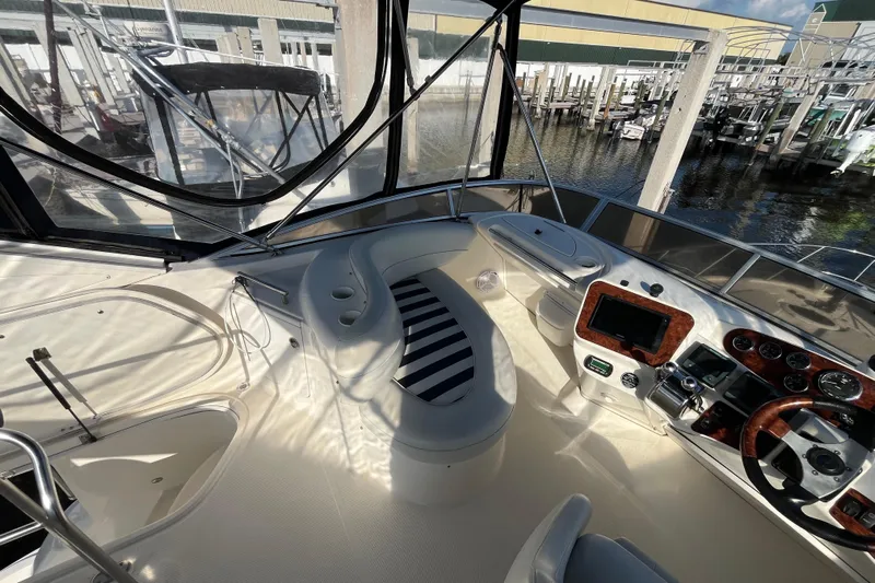 Compass Rose Yacht Photos Pics Interior view of 2006 Meridian 341 Sedan yacht cockpit with steering controls and seating.