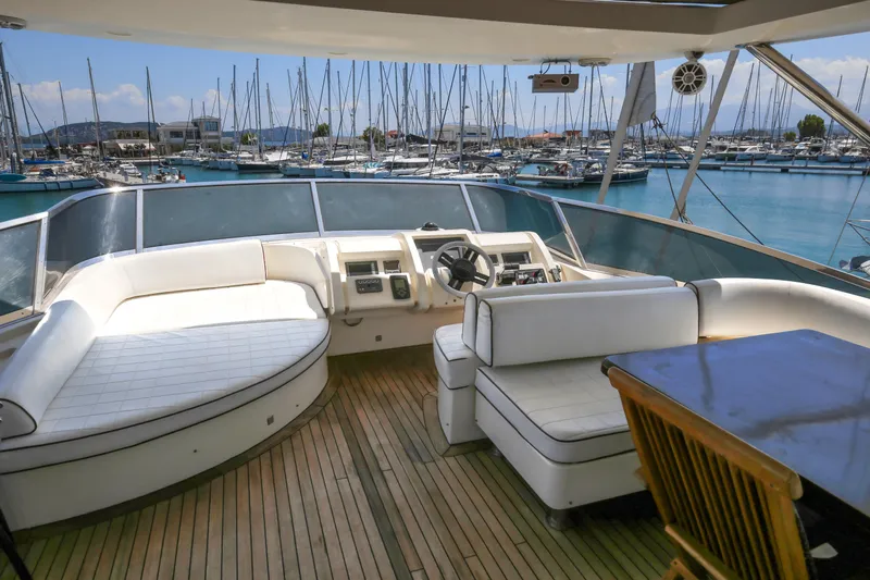  Yacht Photos Pics Luxurious 2010 Azimut Fly 78 yacht interior with marina view, featuring elegant seating and wooden flooring.