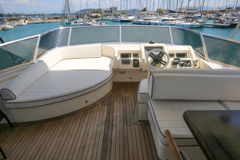  Yacht Photos Pics Luxurious 2010 Azimut Fly 78 yacht deck with white seating and marina view.