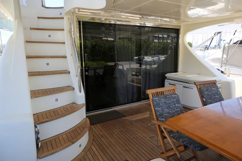  Yacht Photos Pics Luxury Azimut Fly 78 yacht deck with wooden stairs and seating area, 2010 model.