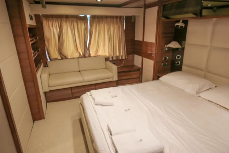  Yacht Photos Pics Luxurious bedroom interior of 2010 Azimut Fly 78 yacht with cozy seating and elegant decor.