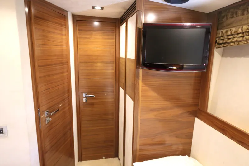  Yacht Photos Pics Interior of 2010 Azimut Fly 78 yacht with wooden doors and wall-mounted TV.