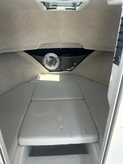  Yacht Photos Pics 2022 Parker 2520 XLD Sport Cabin interior with cushioned seating and storage net.