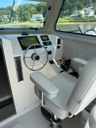  Yacht Photos Pics 2022 Parker 2520 XLD Sport Cabin interior with steering wheel and navigation system.