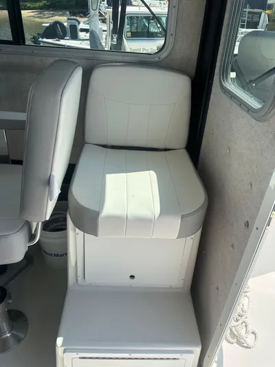  Yacht Photos Pics 2022 Parker 2520 XLD Sport Cabin interior with white cushioned seating.