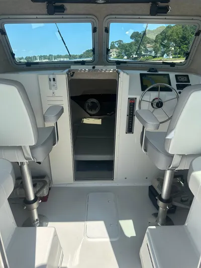  Yacht Photos Pics Interior of 2022 Parker 2520 XLD Sport Cabin boat with modern controls and seating.