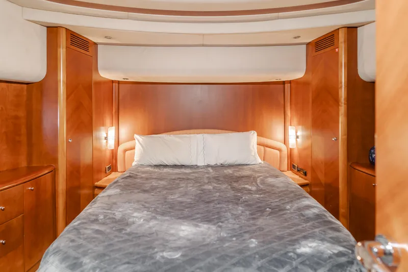 Anejo Yacht Photos Pics Luxurious bedroom interior of 2005 Azimut 85 Ultimate yacht with wood paneling.