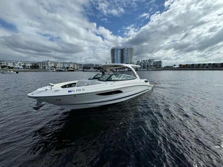  Yacht Photos Pics 2015 Sea Ray 350 SLX boat on water with cityscape background.