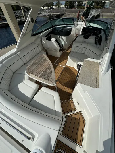  Yacht Photos Pics 2015 Sea Ray 350 SLX boat interior with white seating and wooden flooring.