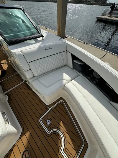  Yacht Photos Pics 2015 Sea Ray 350 SLX boat with white seating and wooden deck by the water.