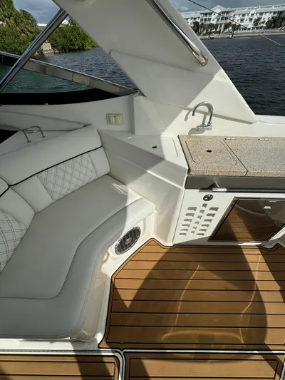  Yacht Photos Pics 2015 Sea Ray 350 SLX boat interior with seating, kitchenette, and wood flooring.