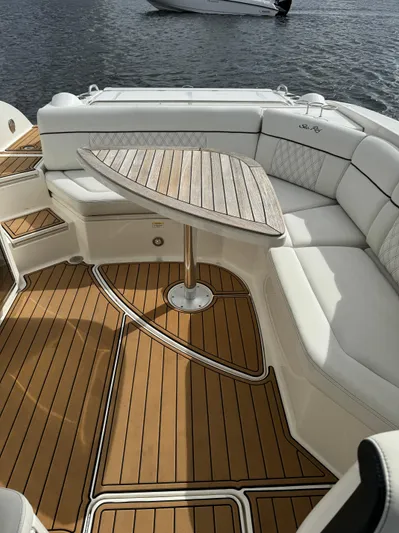  Yacht Photos Pics 2015 Sea Ray 350 SLX boat with elegant seating and wooden table on deck.