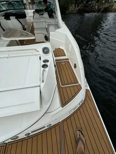  Yacht Photos Pics 2015 Sea Ray 350 SLX boat deck with teak flooring, docked by the water.