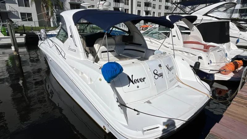 Lowest Price In Usa ! Yacht Photos Pics 2008 Sea Ray 380 Sundancer yacht docked at marina, featuring blue canopy and sleek design.