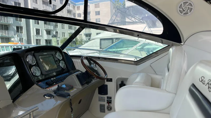 Lowest Price In Usa ! Yacht Photos Pics 2008 Sea Ray 380 Sundancer cockpit with modern controls and white seating.