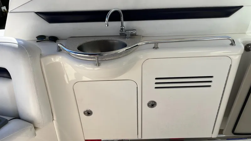 Lowest Price In Usa ! Yacht Photos Pics 2008 Sea Ray 380 Sundancer boat kitchenette with sink and storage cabinets.