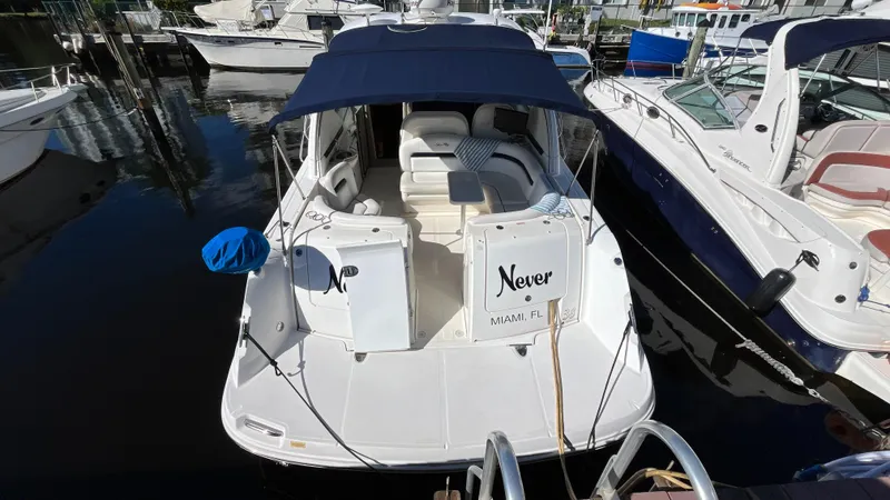 Lowest Price In Usa ! Yacht Photos Pics 2008 Sea Ray 380 Sundancer docked, featuring a blue canopy and white seating.