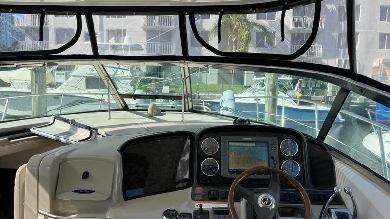 Lowest Price In Usa ! Yacht Photos Pics Cockpit view of 2008 Sea Ray 380 Sundancer with navigation system and marina backdrop.