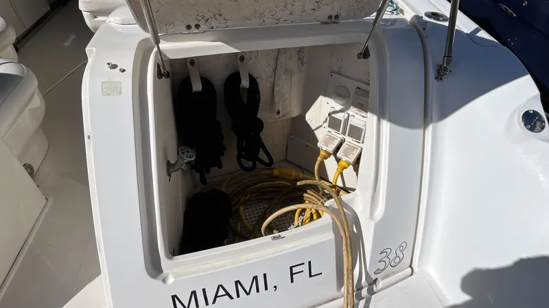 Lowest Price In Usa ! Yacht Photos Pics Open storage compartment on 2008 Sea Ray 380 Sundancer, Miami, FL, with cables and equipment.