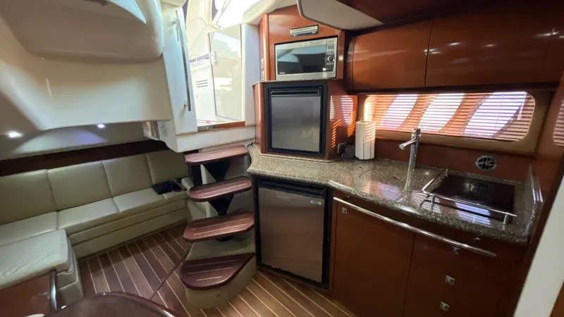 Lowest Price In Usa ! Yacht Photos Pics Interior of 2008 Sea Ray 380 Sundancer yacht with kitchen and seating area.