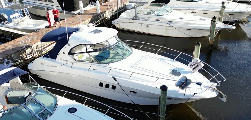 Lowest Price In Usa ! Yacht Photos Pics 2008 Sea Ray 380 Sundancer yacht docked at marina, surrounded by other boats.