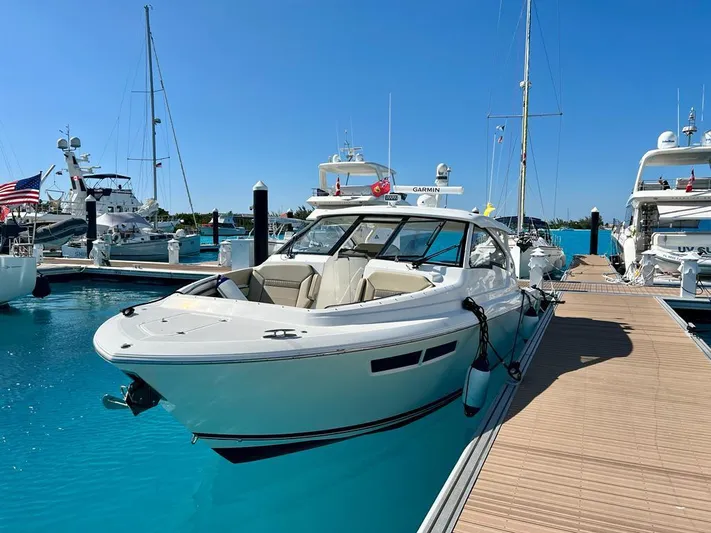  Yacht Photos Pics 2020 Pursuit DC 365 Dual Console boat docked in a marina under clear blue skies.