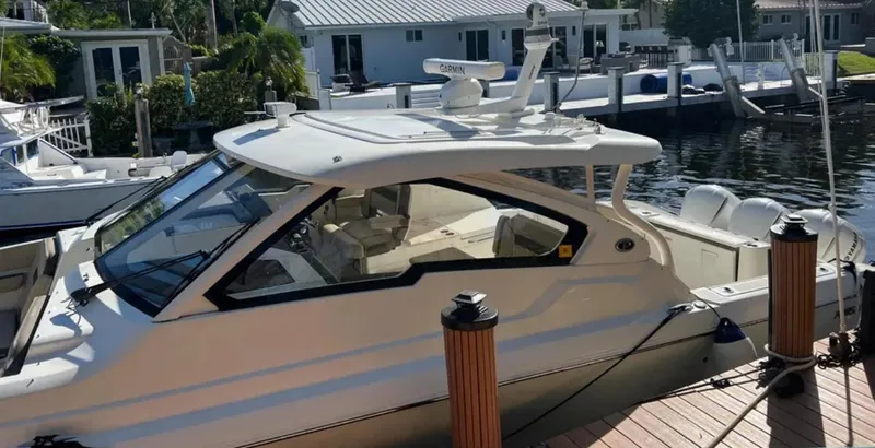  Yacht Photos Pics 2020 Pursuit DC 365 Dual Console boat docked at a marina.