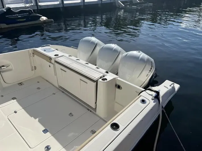  Yacht Photos Pics 2020 Pursuit DC 365 Dual Console boat with triple outboard engines docked.