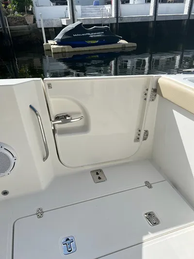  Yacht Photos Pics 2020 Pursuit DC 365 Dual Console boat interior with open door and docked jet ski.