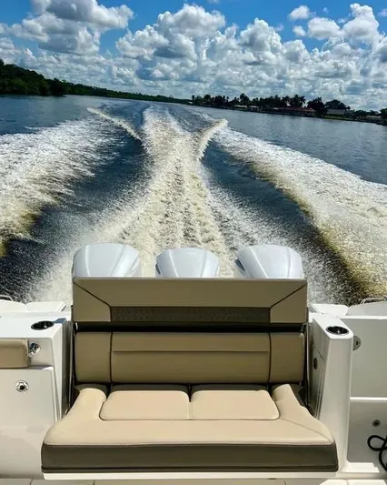  Yacht Photos Pics 2020 Pursuit DC 365 Dual Console boat cruising on a sunny day, leaving a wake trail.