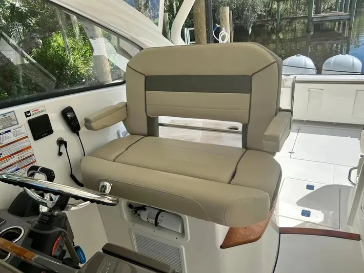  Yacht Photos Pics 2020 Pursuit DC 365 Dual Console boat interior with beige seating and control panel.