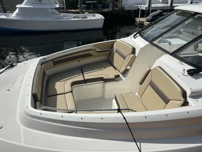  Yacht Photos Pics 2020 Pursuit DC 365 Dual Console boat with spacious seating in a marina.