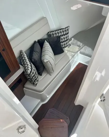  Yacht Photos Pics 2020 Pursuit DC 365 Dual Console interior with cushioned seating and decorative pillows.